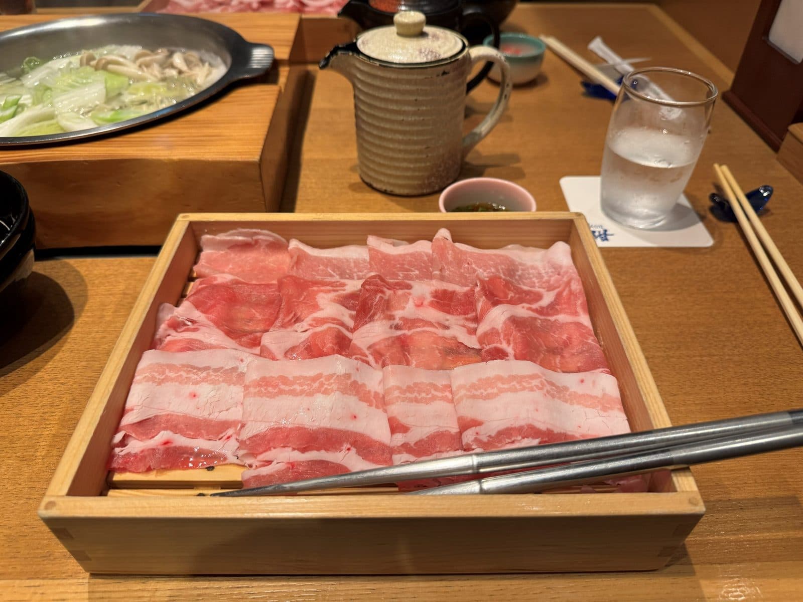 木盒裝的阿古豬肉片,後方是涮涮鍋的鍋子